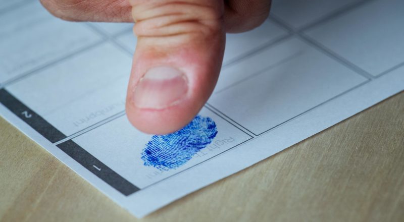 thumbprint being marked on a fingerprint chart